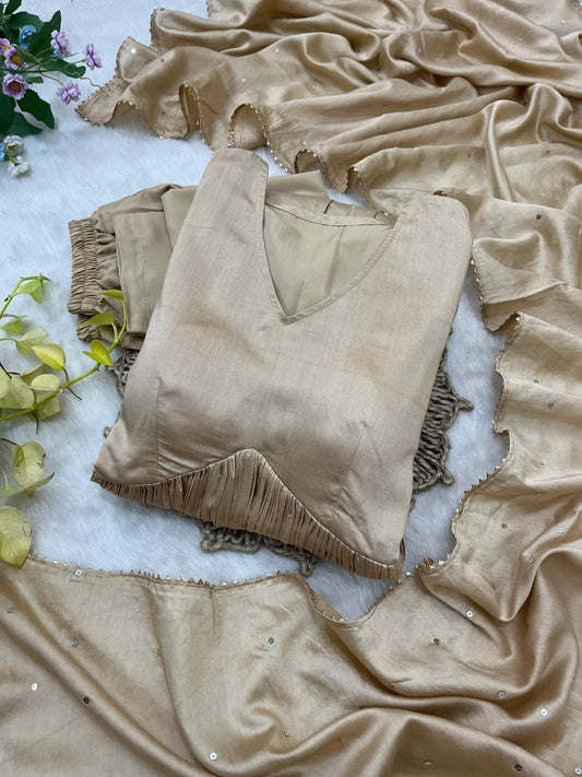 Beige velvet top with ruffled details on a textured surface with green leaves. Beige Anarkali Suit Set Roohri 