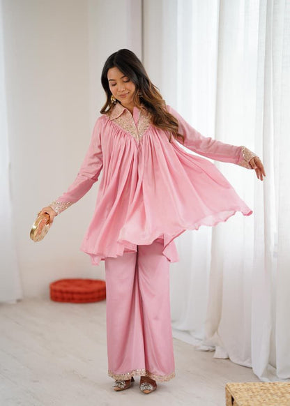 Woman wearing a pink traditional outfit in a bright room with white curtains. Pink Co-ord Set