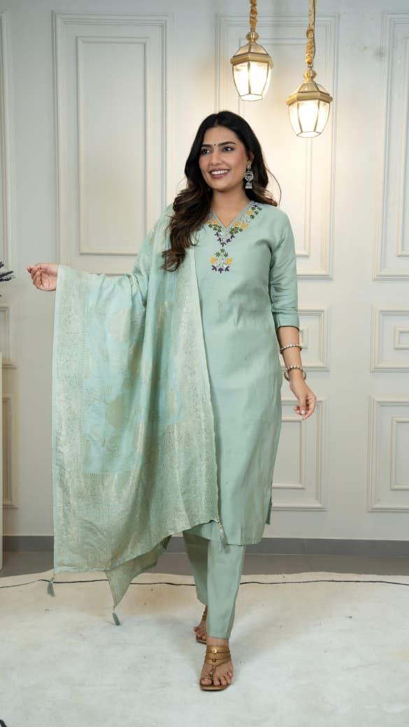 Woman wearing a light green traditional outfit with a matching dupatta in a well-lit room. sea green suit set roohri
