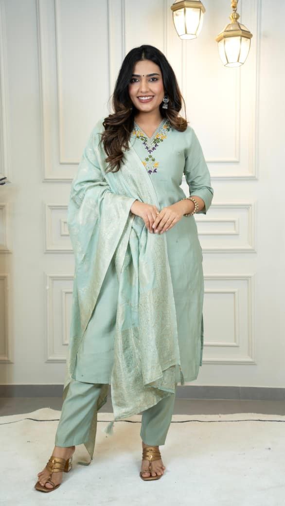 Woman wearing a light green traditional outfit with a dupatta in an indoor setting. sea green suit set roohri